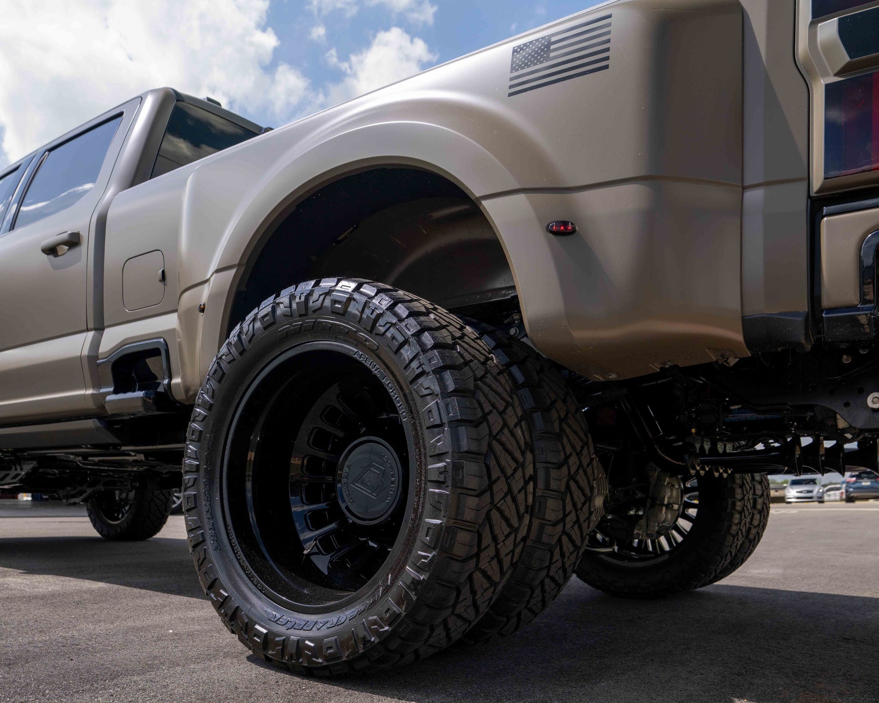 Close-up of a Marsh Gray F450 Platinum plus with large off-road tires and Arena Shoreline Wheels