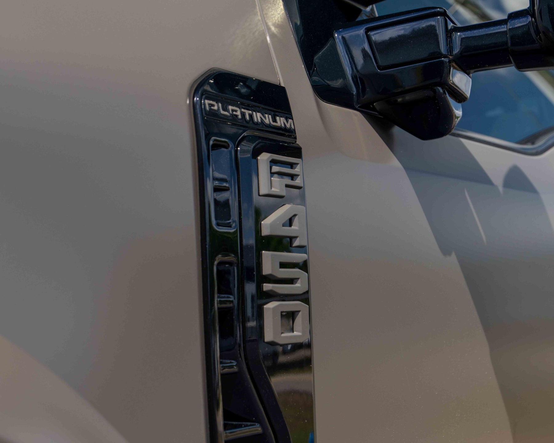 Close-up of a Ford F450 Platinum Plus Marsh Gray Painted Emblems 
